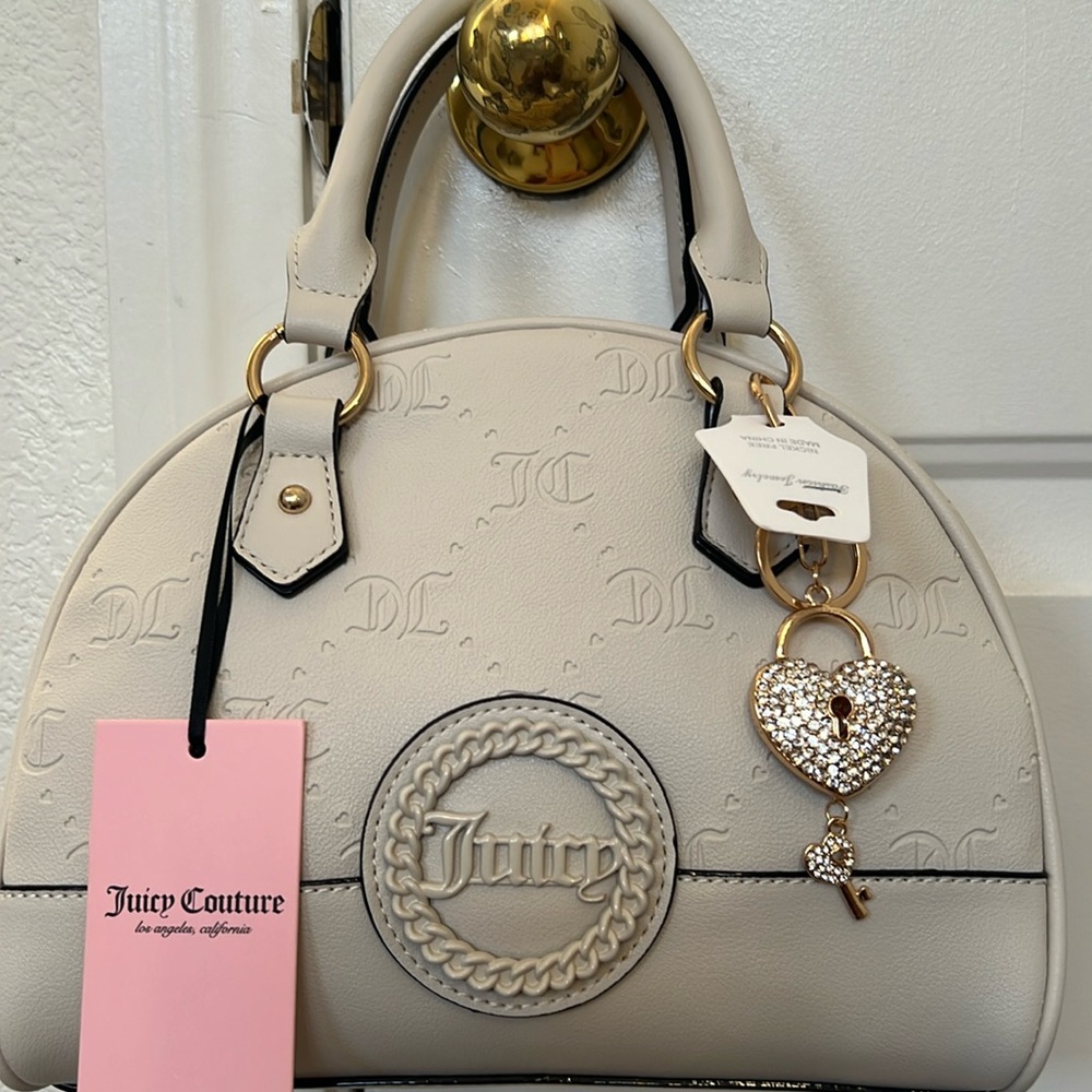 JUICY COUTURE - AND IT IS JUICY. NWT
“ANGEL STAY IN CIRCLE” BOWLER IN ECRU.